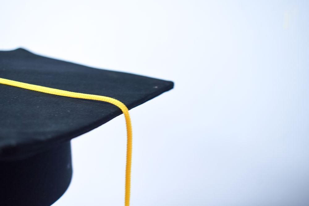 Side view of graduation cap in plain studio with space for text