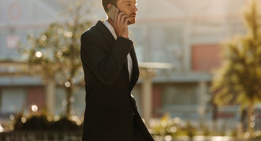 Man talking over mobile phone outdoors