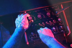 Unrecognizable DJ playing on audio mixer