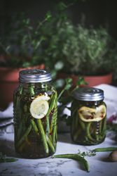 Glass jar with preserved yellow and green vegetables
