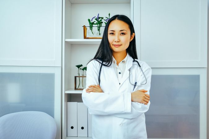 Confident Asian woman doctor in her office