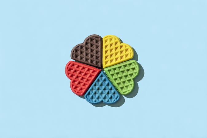 Rainbow waffles top view on a blue background