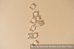 Flat lay of ice cubes on beige background with shadows bxjWa5