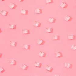 Ice cubes pattern on pastel pink background