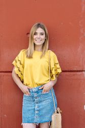 Cheerful woman standing on orange background