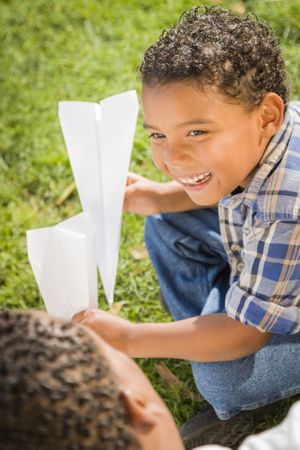 Father and Son Having Fun with Paper Airplanes