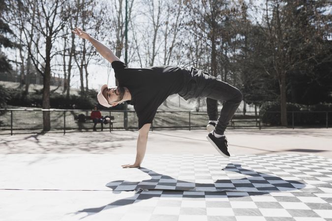 Man dancing break dance in park