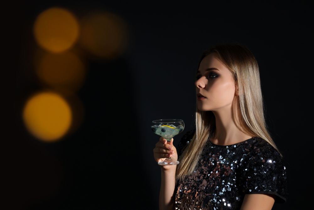 Concept of Halloween, young woman on dark background