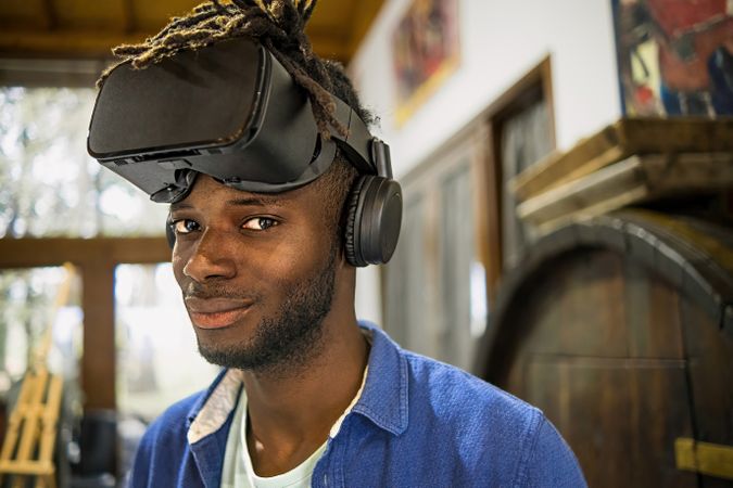 Black man with VR goggles on the head looking at the camera