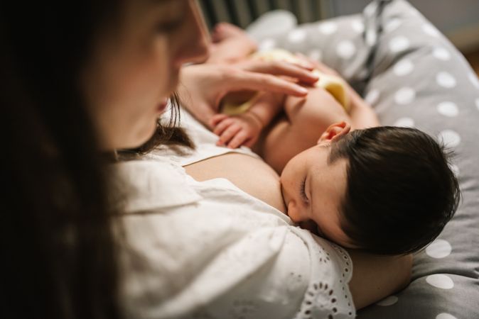 Mother feeding baby at home