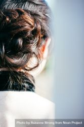 Close up cropped shot of woman’s head with hair bun style and brunette hair bYqVYb