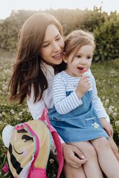 Mother and daughter sitting on lawn