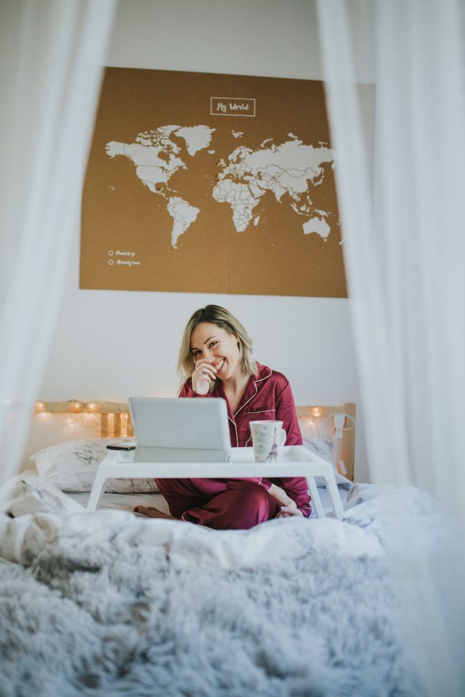Woman sitting in bed with tablet