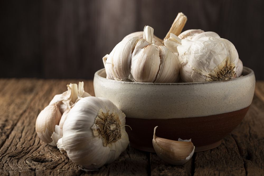 Garlic bulb and garlic cloves on the wooden table.