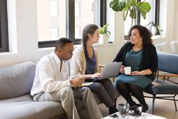 Two women and a man having work-related meeting