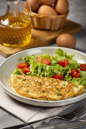 Omelet with cheese and lettuce and tomato salad.