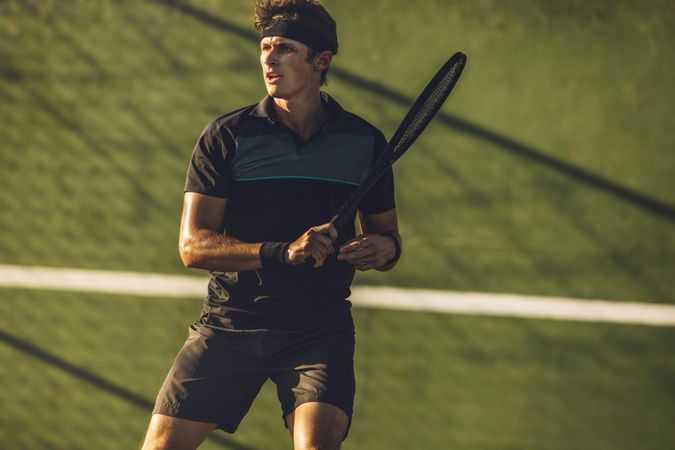 Pro tennis player practicing tennis on a club court