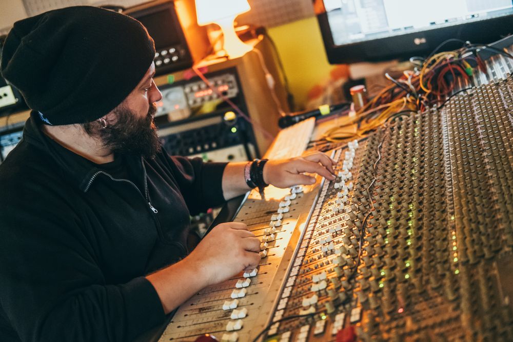Man in a equalizer instrument in a studio