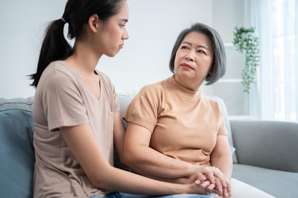 Asian mature mother comforting her daughter