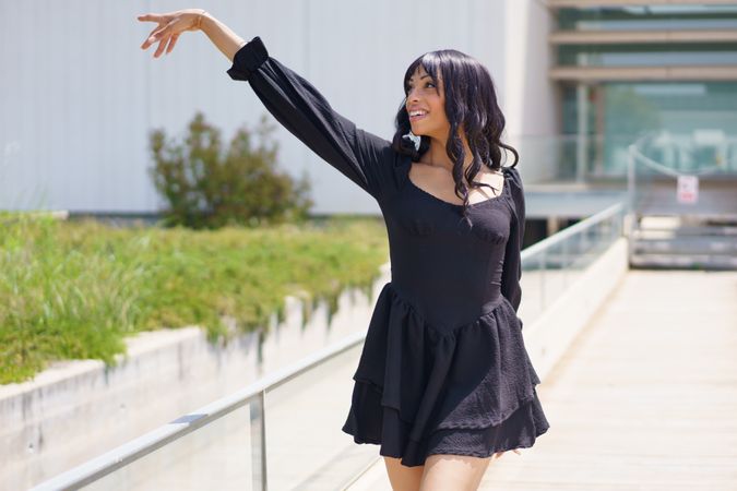 Woman dancing outside on sunny day