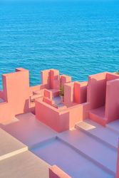 Pink wall construction against blue sea