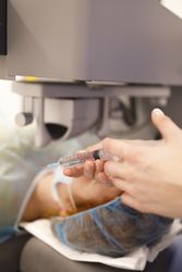 Surgeon holding syringe in operating theater