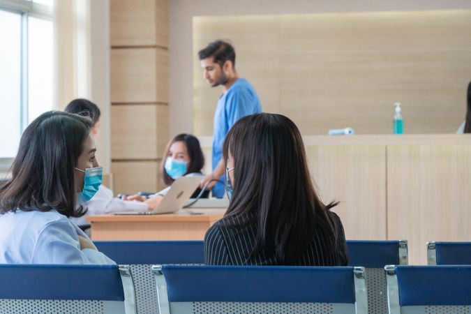 Multi-ethnic group of people in hospital waiting room