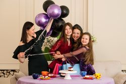 Teen with woman and two young girls. Birthday Party
