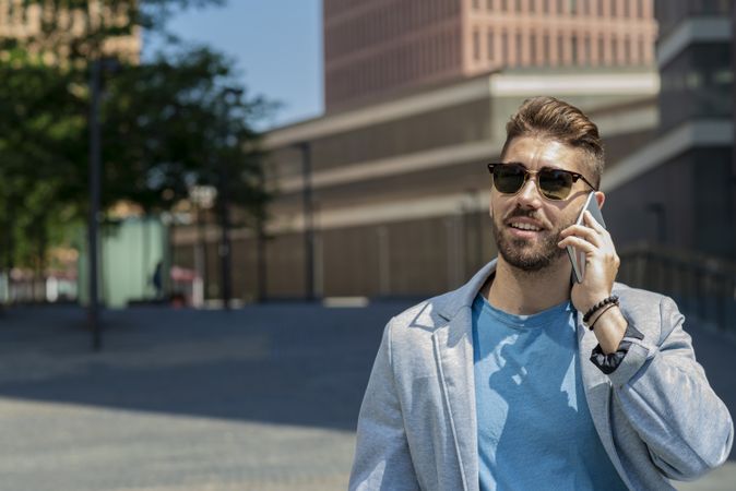 Portrait of young businessman talking on his phone outdoors