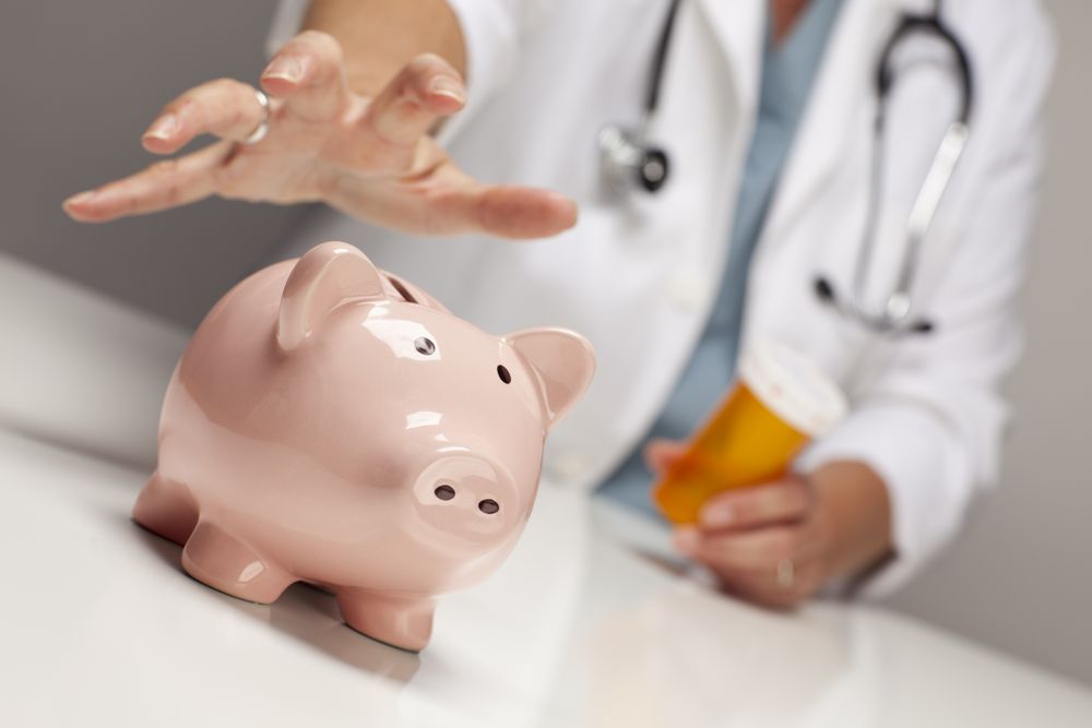 Doctor with Medicine Bottles Reaches for Piggy Bank.