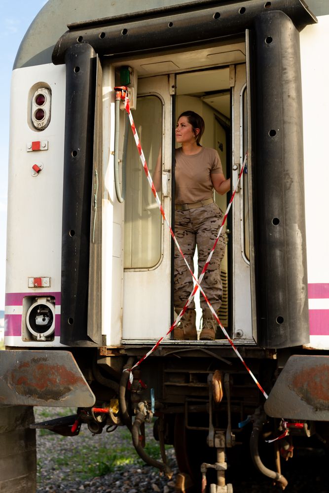 Military woman standing inside railway wagon