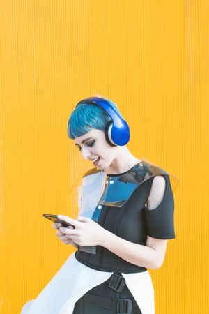 Futuristic woman using smartphone and listening to music