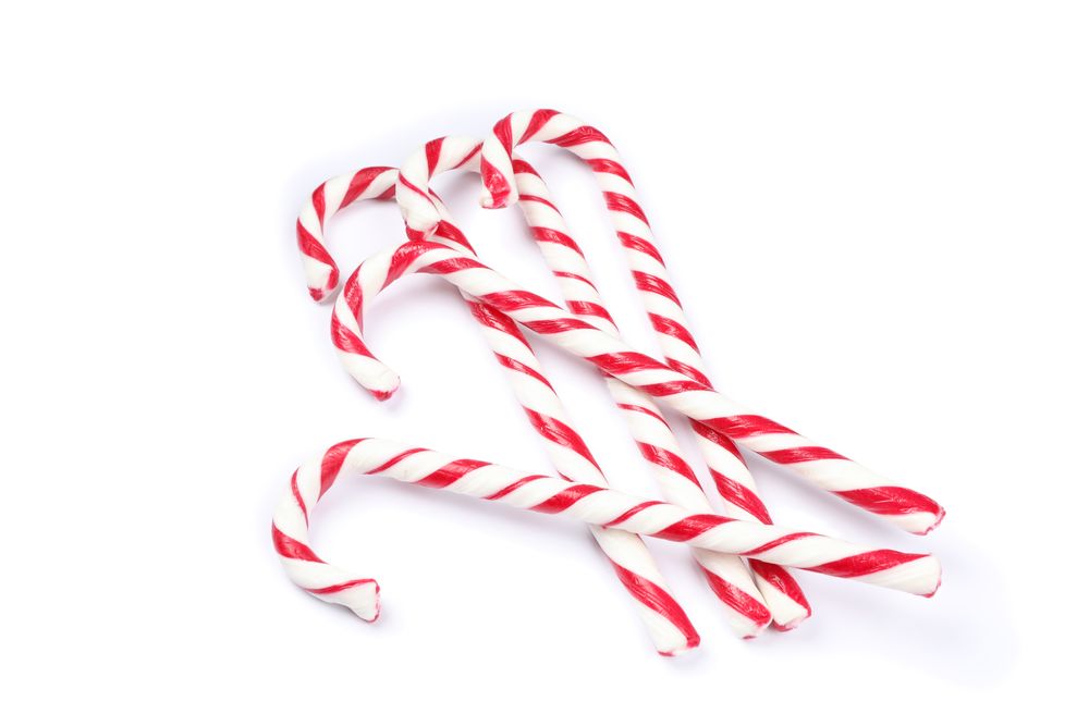 Sweet candy canes isolated on blank background