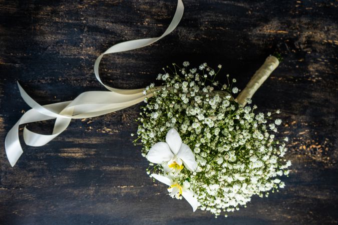 Bridal bouquet of gypsophila paniculata flowers on wooden table