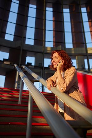 young female communicating via smartphone at station
