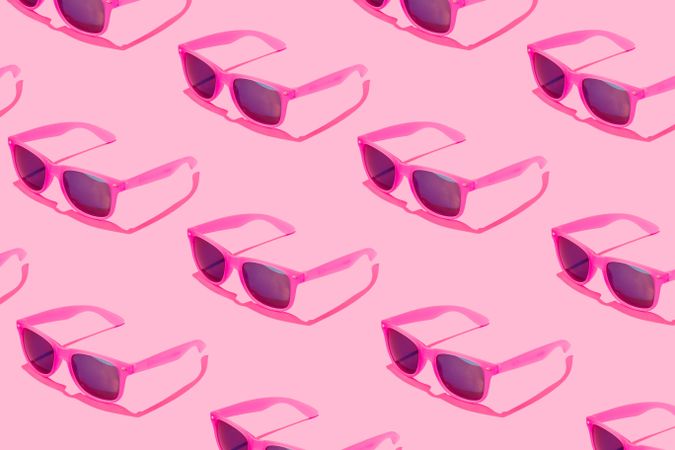 Pattern of pink sunglasses on blue background
