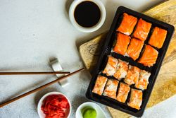 Top view of to go box of California sushi rolls