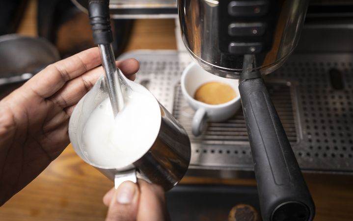 Barista making coffee with latte art