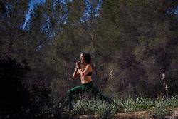 Fit female practicing Crescent Lunge with Prayer Hands po