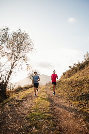 Sportive men running in mountains
