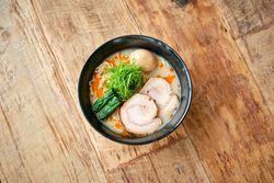 Delicious ramen soup on wooden table