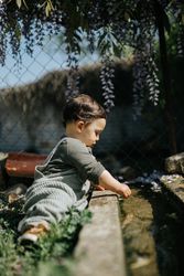 Side view of toddler exploring garden