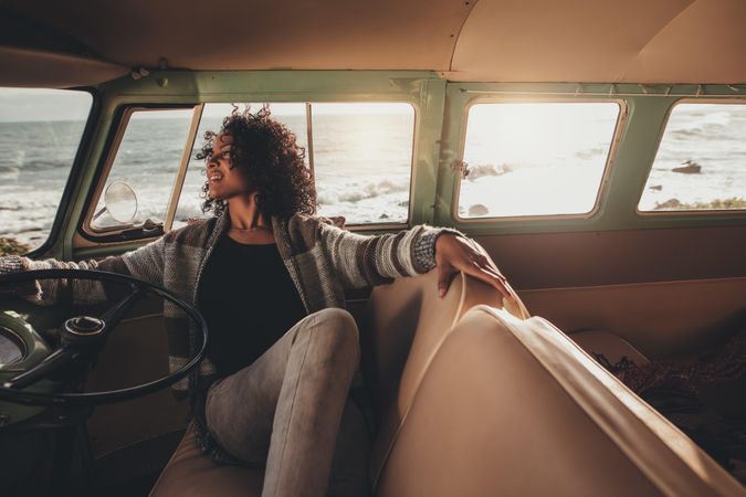 Black woman sitting in a van and relaxing