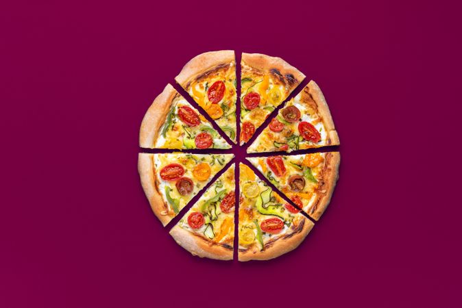 Homemade pizza with vegetables minimalist on a magenta table