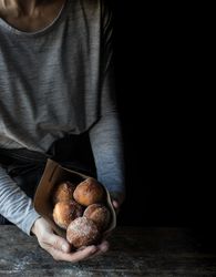 Person near baked cakes on table