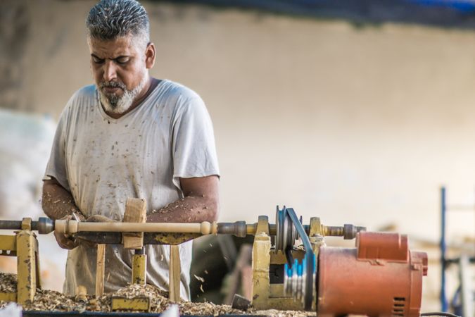 Man using woodworking machine at workplace