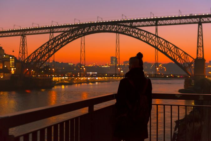 Female walking on embankment during sundown