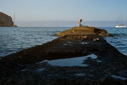 Young woman practicing yoga at seaside