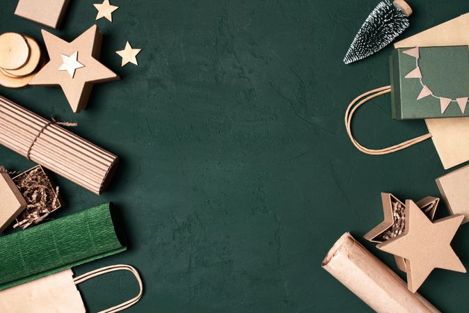 Gift wrapping accessories on green background with copy space