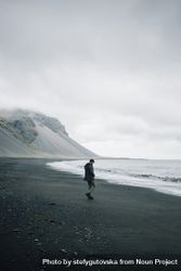 Man walking along coastline on a winter’s day 5nD1Ab